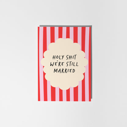 Card with red and white striped design and text 'HOLY SHIT WE'RE STILL MARRIED' on a white background