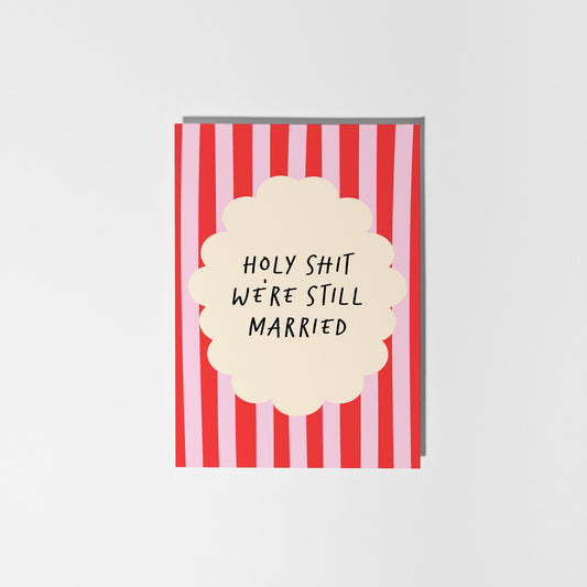 Card with red and white striped design and text 'HOLY SHIT WE'RE STILL MARRIED' on a white background