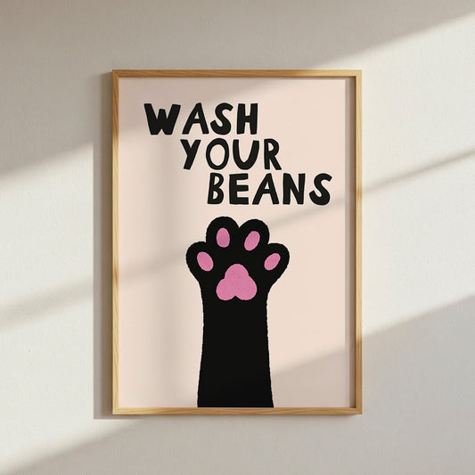 Framed artwork with a paw print and text 'Wash Your Beans' on a light background